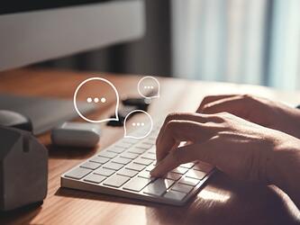 Person typing at computer